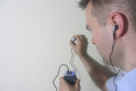 man testing listen through wall device