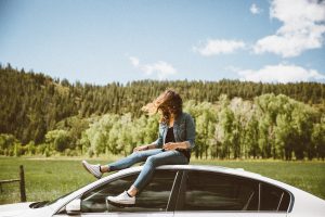 teenager sat on car