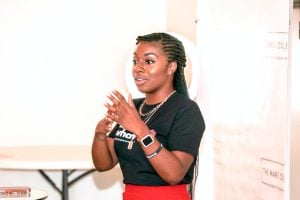 woman giving speech with voice recorder