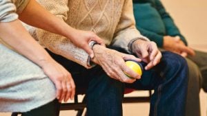 person holding elderly mans hand